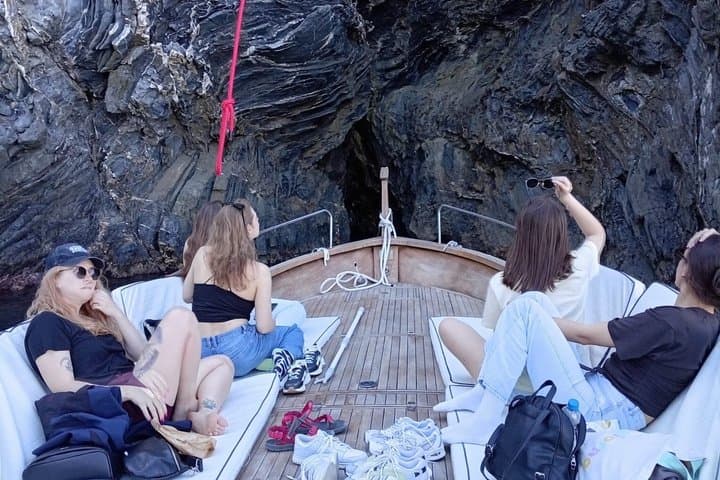 Boat ride from Riomaggiore with stop for swimming and local wine.